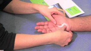 A hand receiving a scar desensitisation massage after receiving carpal tunnel treatment